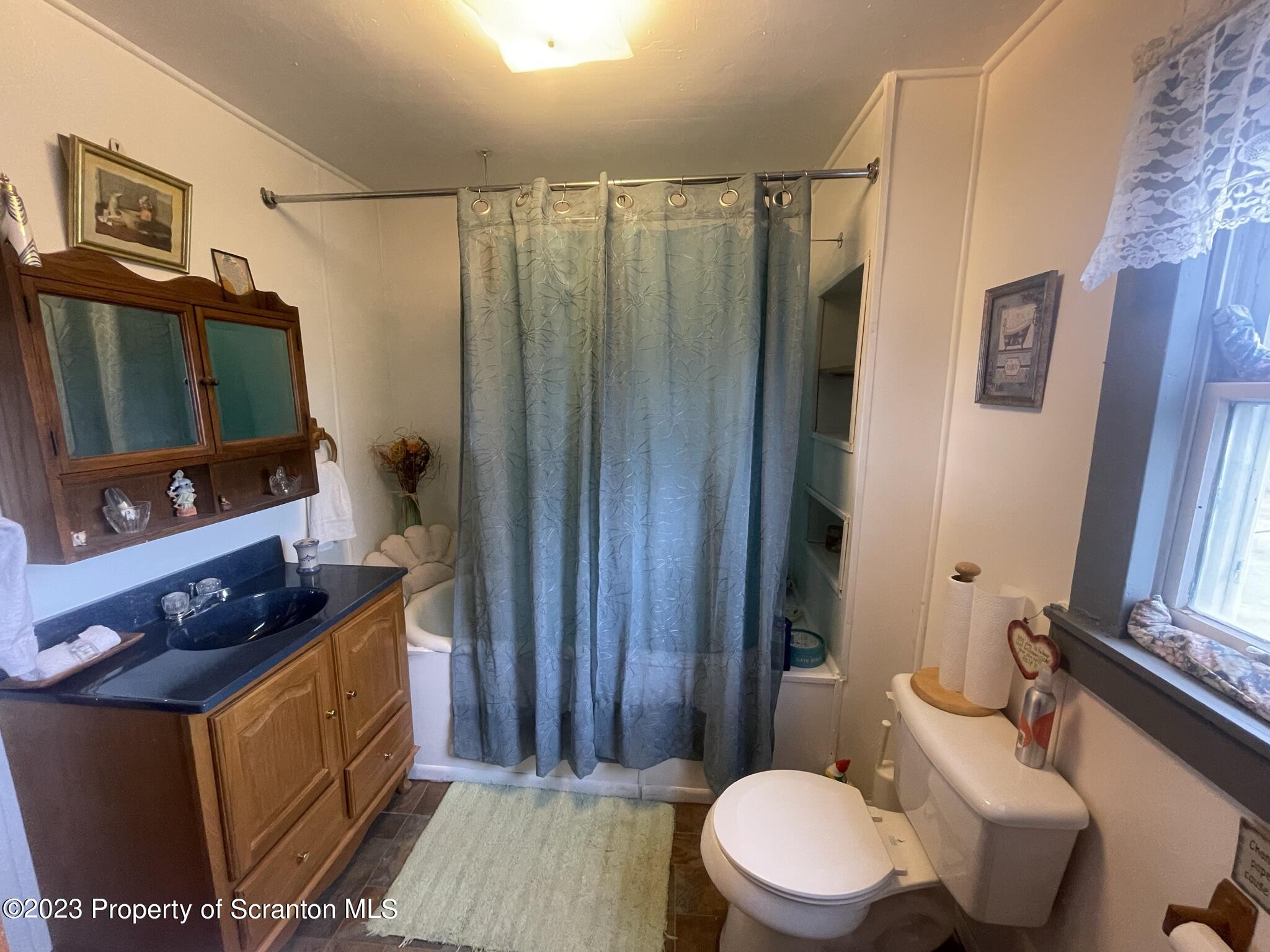 176 Stack Road Thompson, PA 18465 - Photo 23 of 53 a bathroom with a granite countertop sink toilet and shower