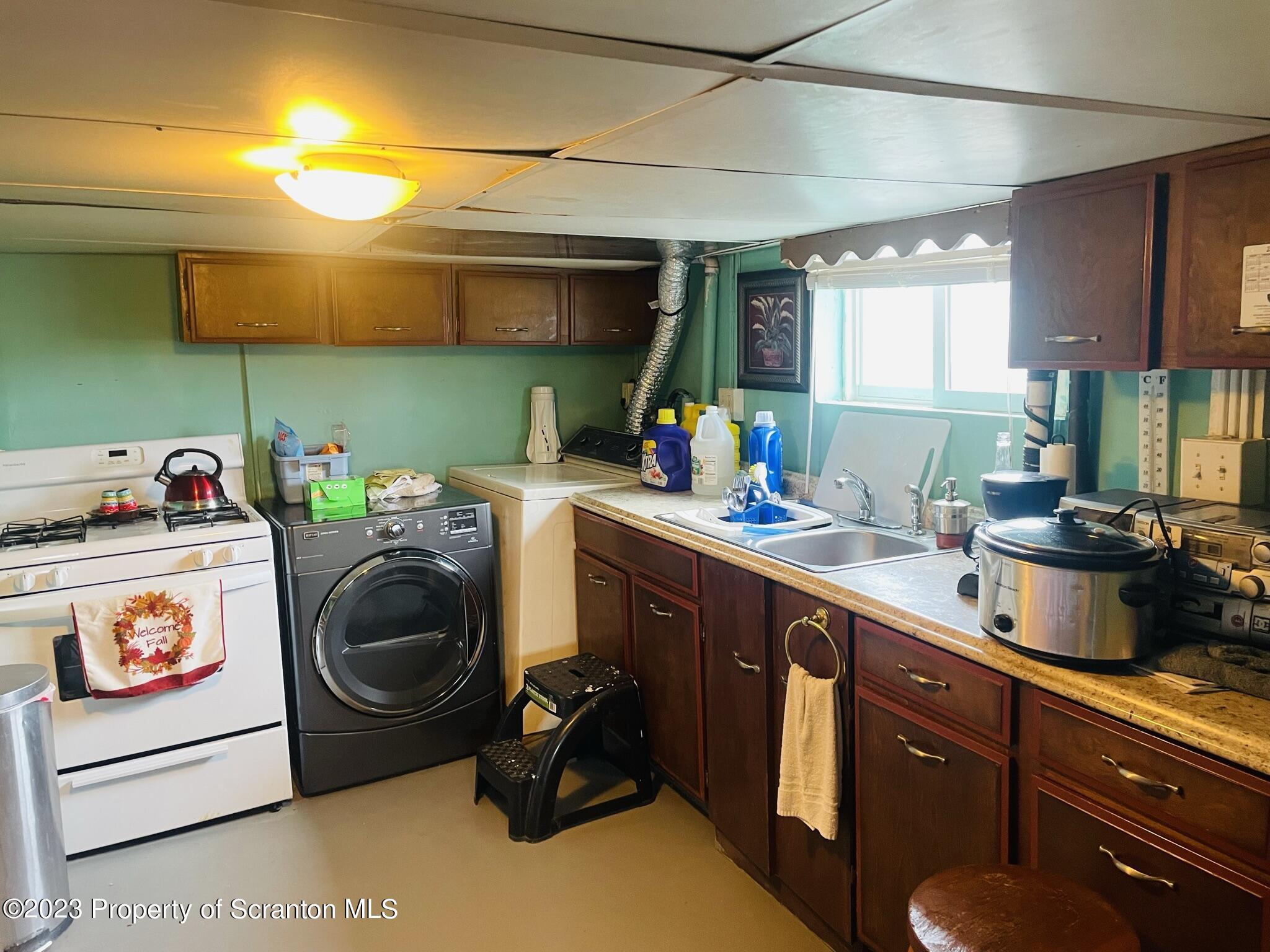 176 Stack Road Thompson, PA 18465 - Photo 26 of 53 a kitchen with kitchen island granite countertop a sink and a stove top oven