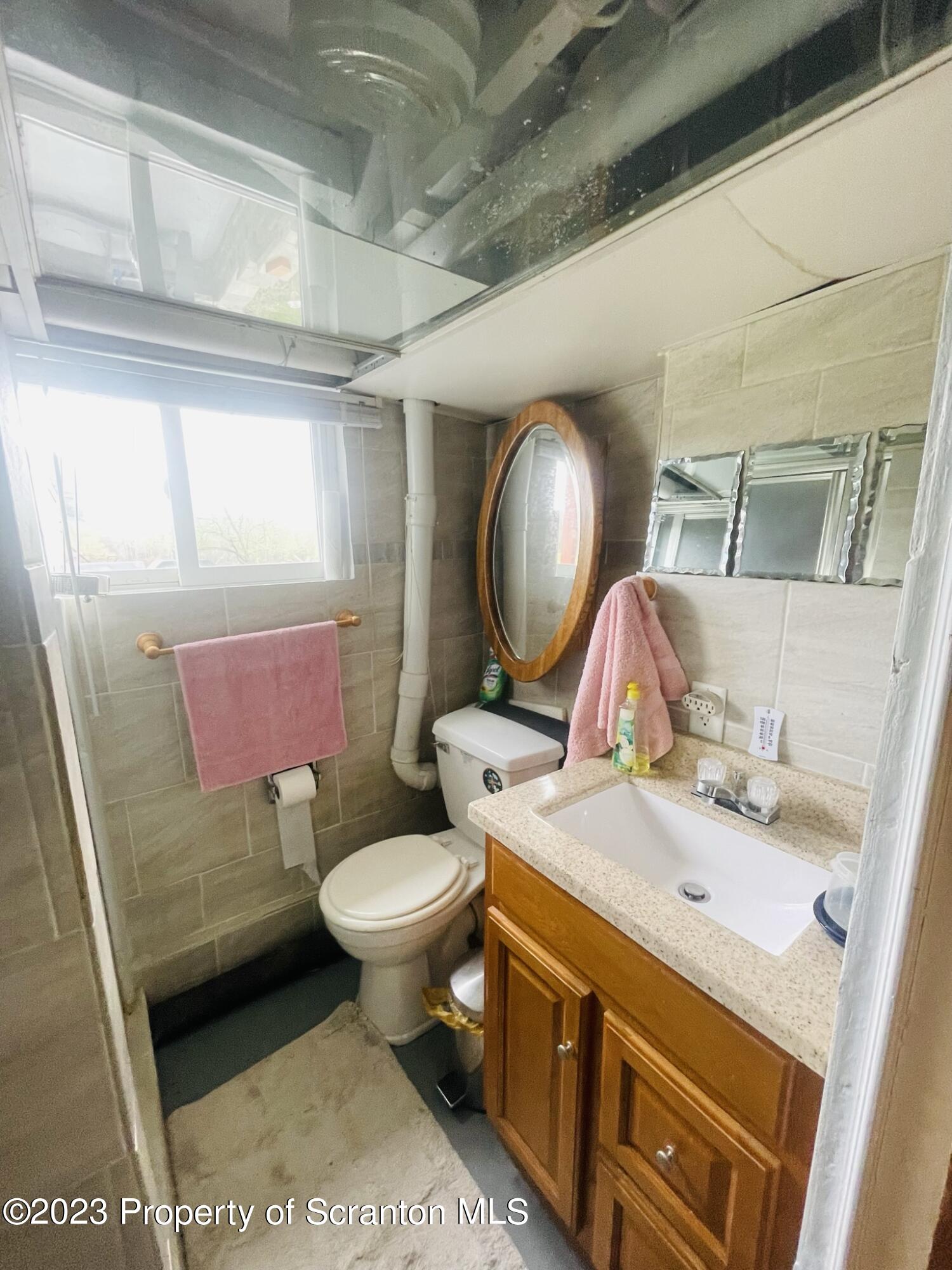 176 Stack Road Thompson, PA 18465 - Photo 27 of 53 a bathroom with a sink toilet and mirror