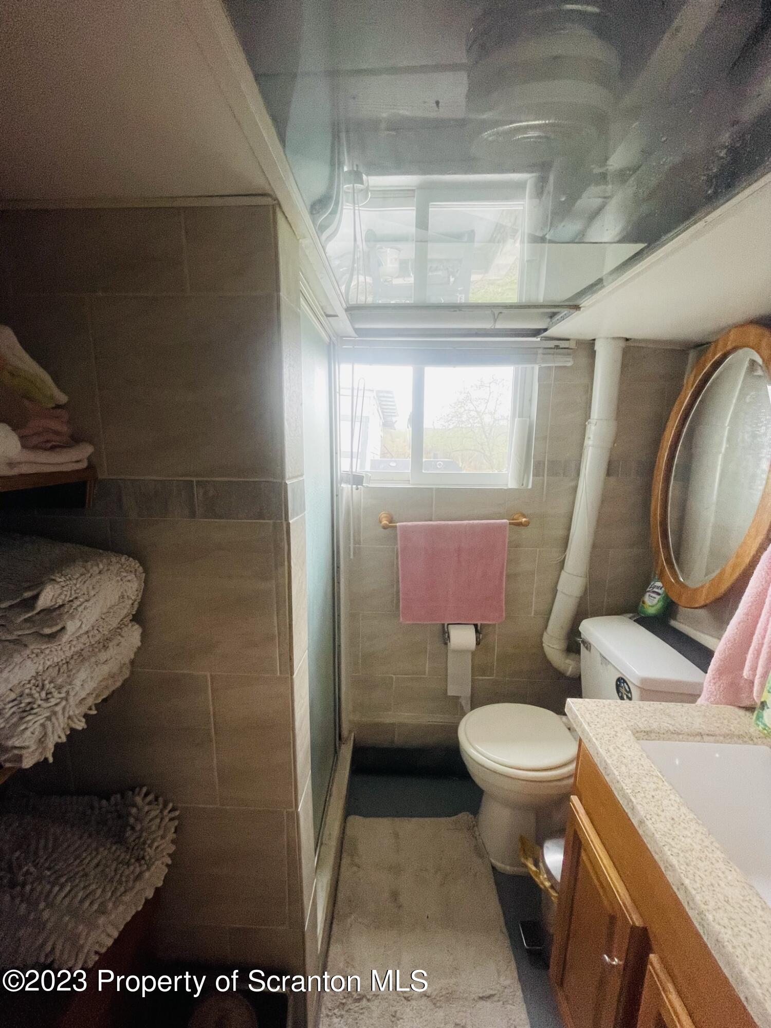 176 Stack Road Thompson, PA 18465 - Photo 28 of 53 a bathroom with a toilet and a sink