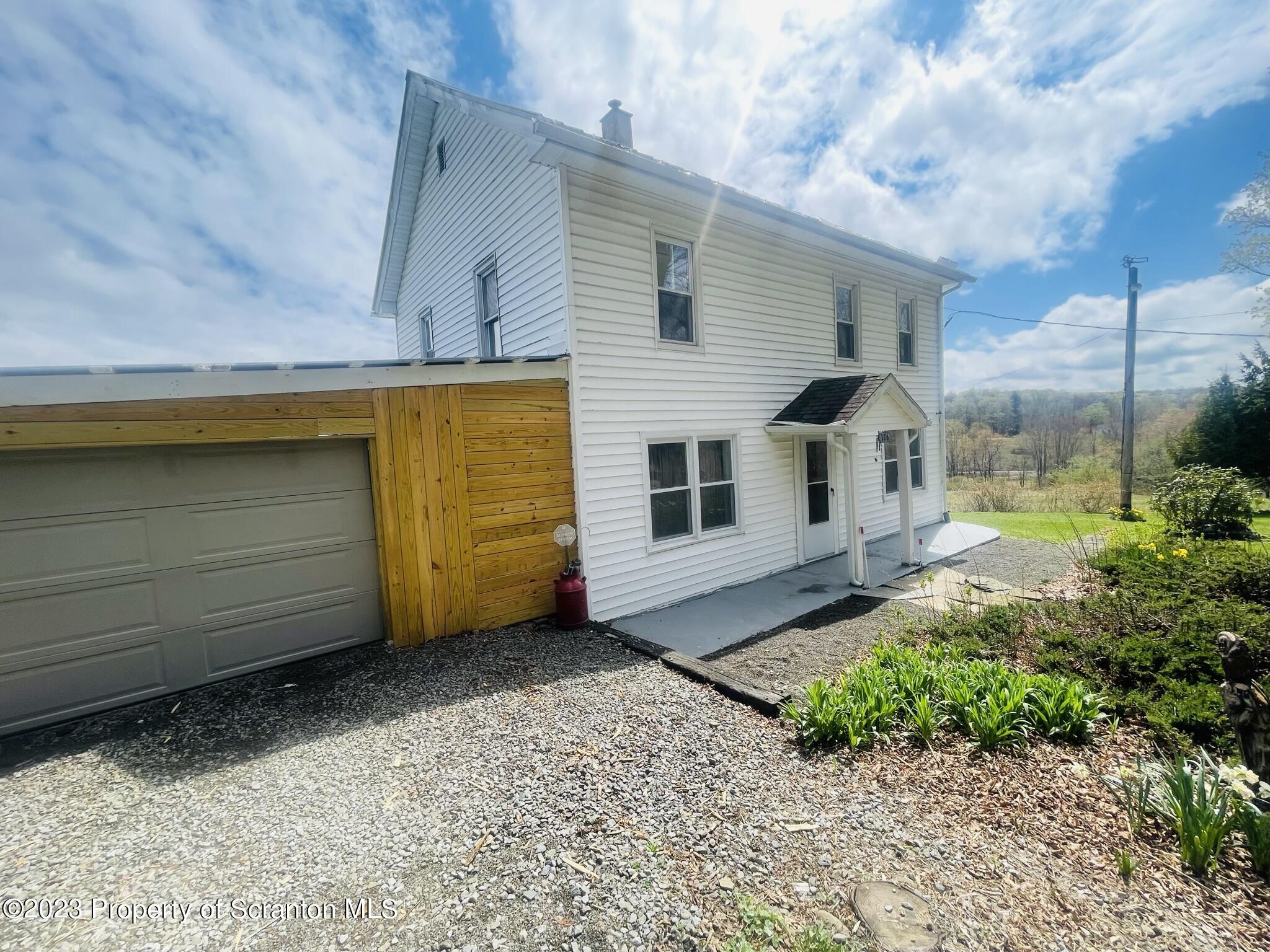 176 Stack Road Thompson, PA 18465 - Photo 29 of 53 a view of a house with a yard