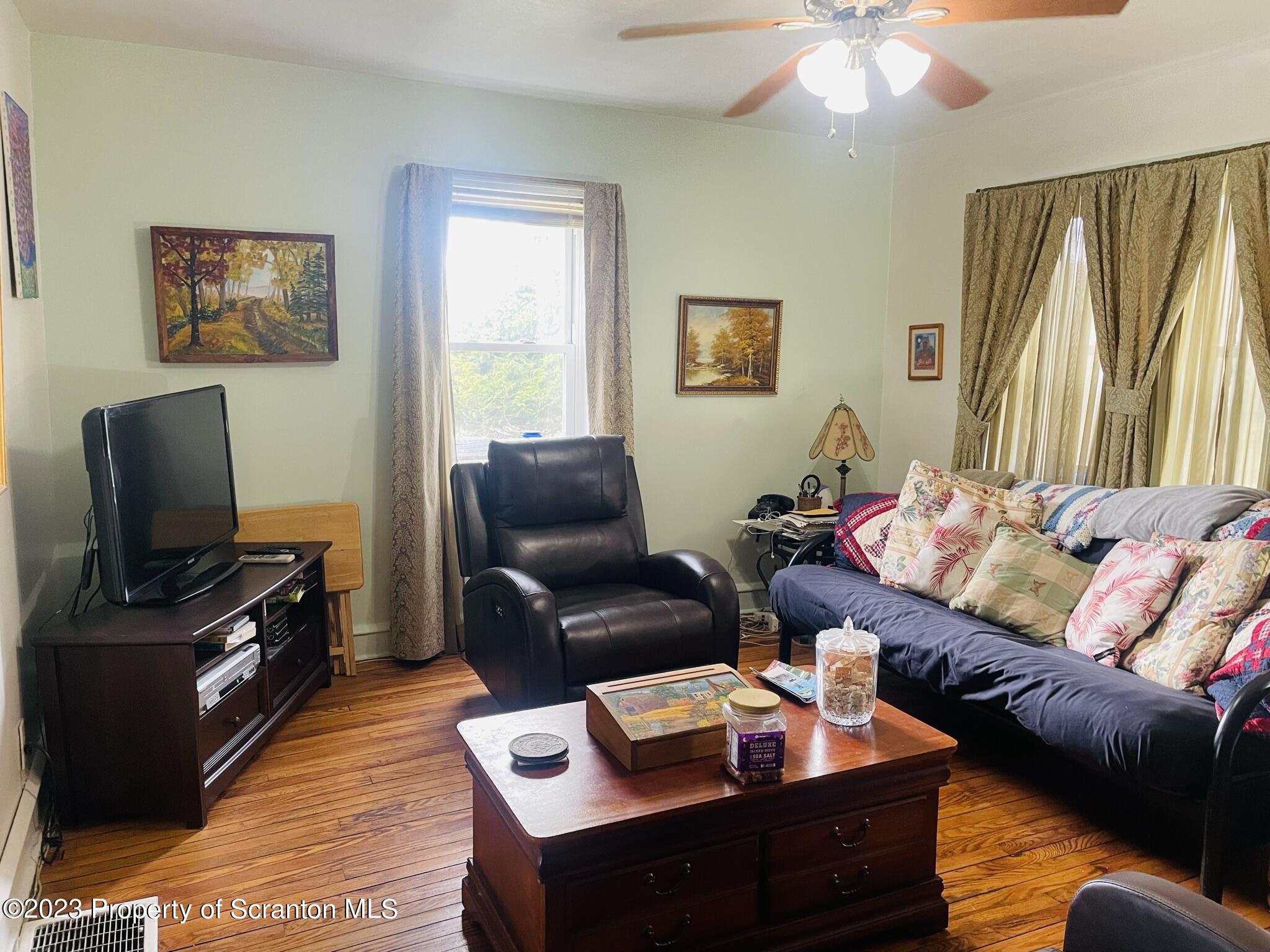 176 Stack Road Thompson, PA 18465 - Photo 3 of 53 a living room with furniture and a flat screen tv