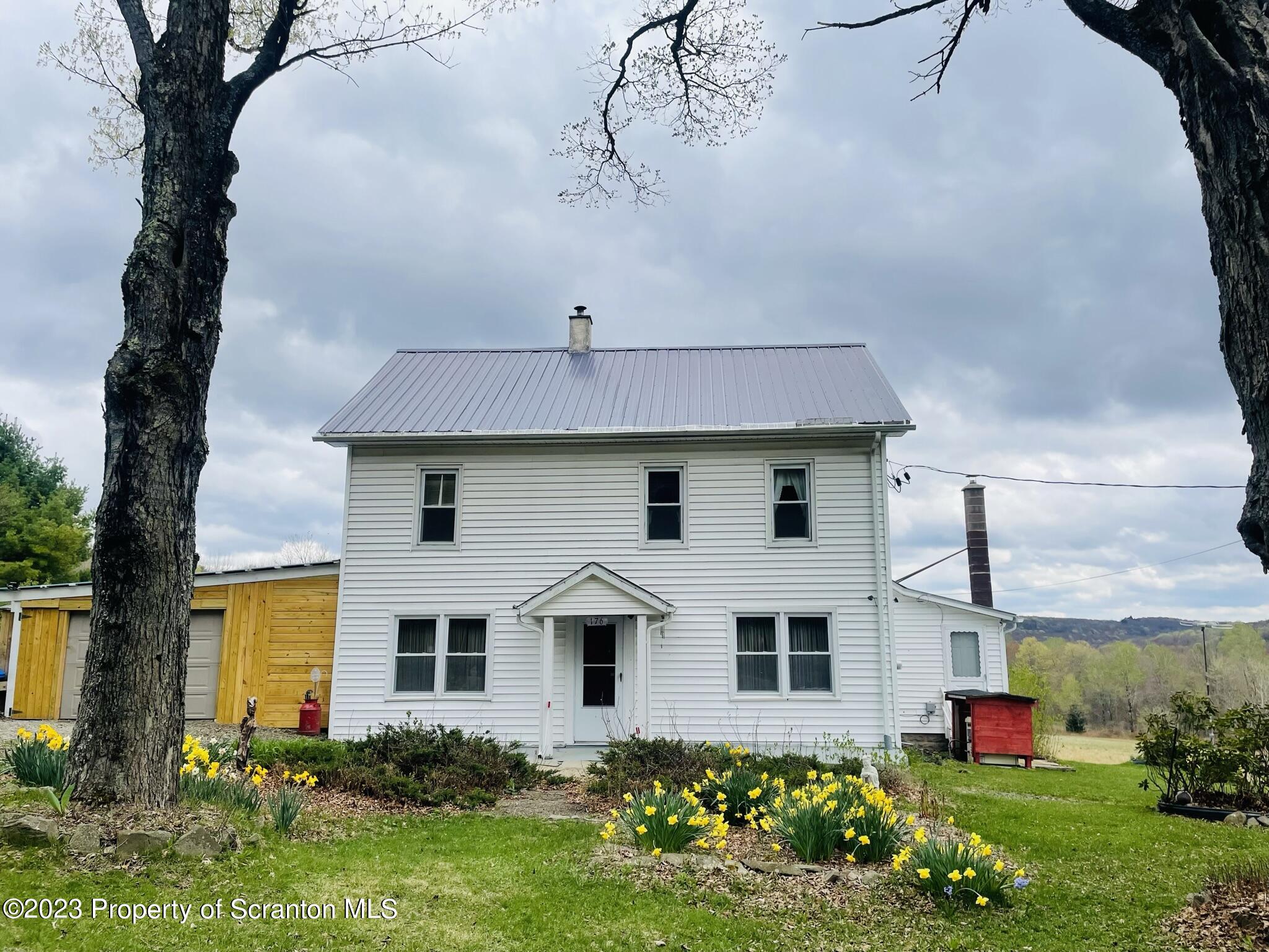 176 Stack Road Thompson, PA 18465 - Photo 31 of 53 a front view of house with yard and trees
