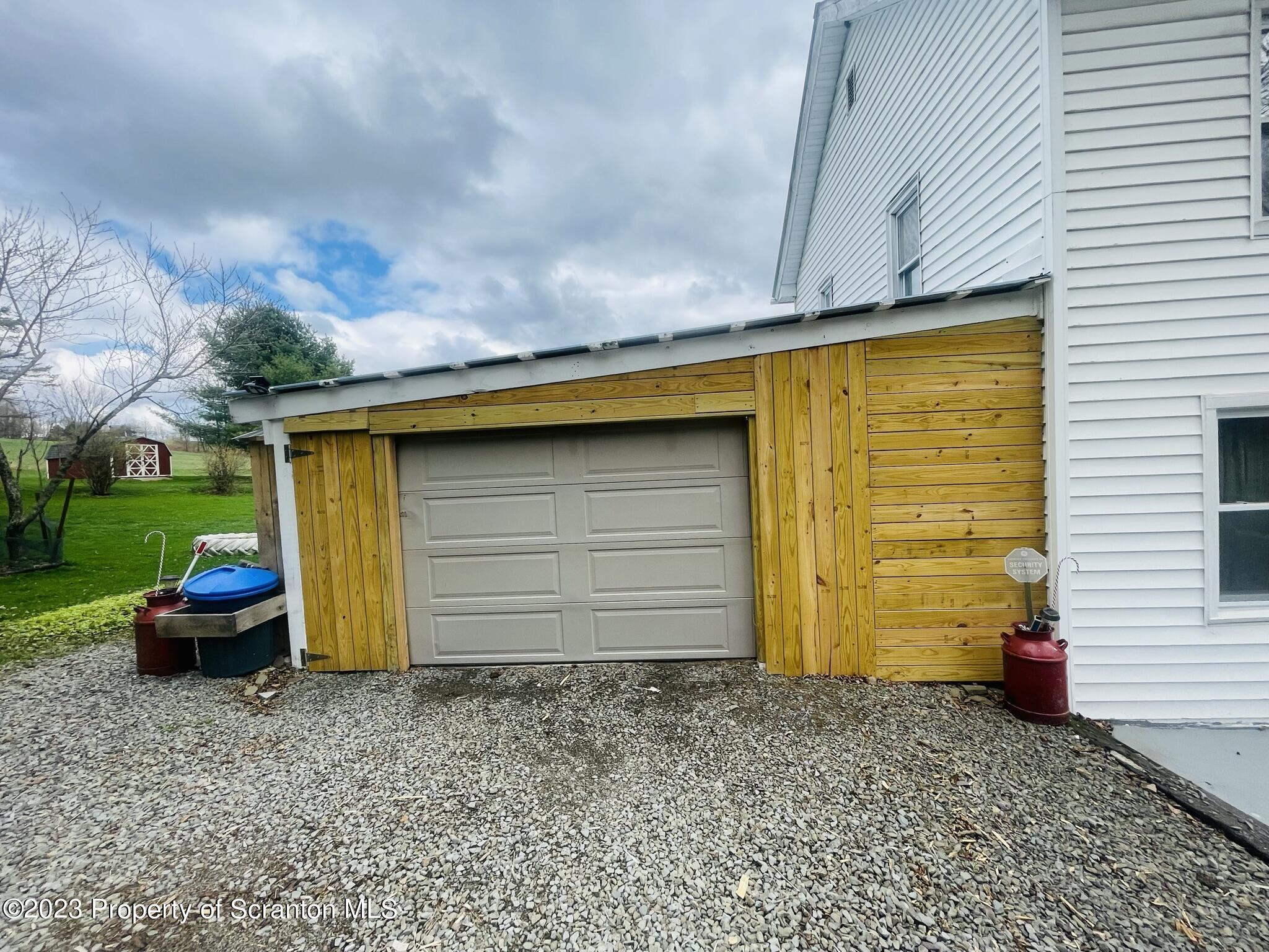 176 Stack Road Thompson, PA 18465 - Photo 32 of 53 a couple of potted plants in front of door