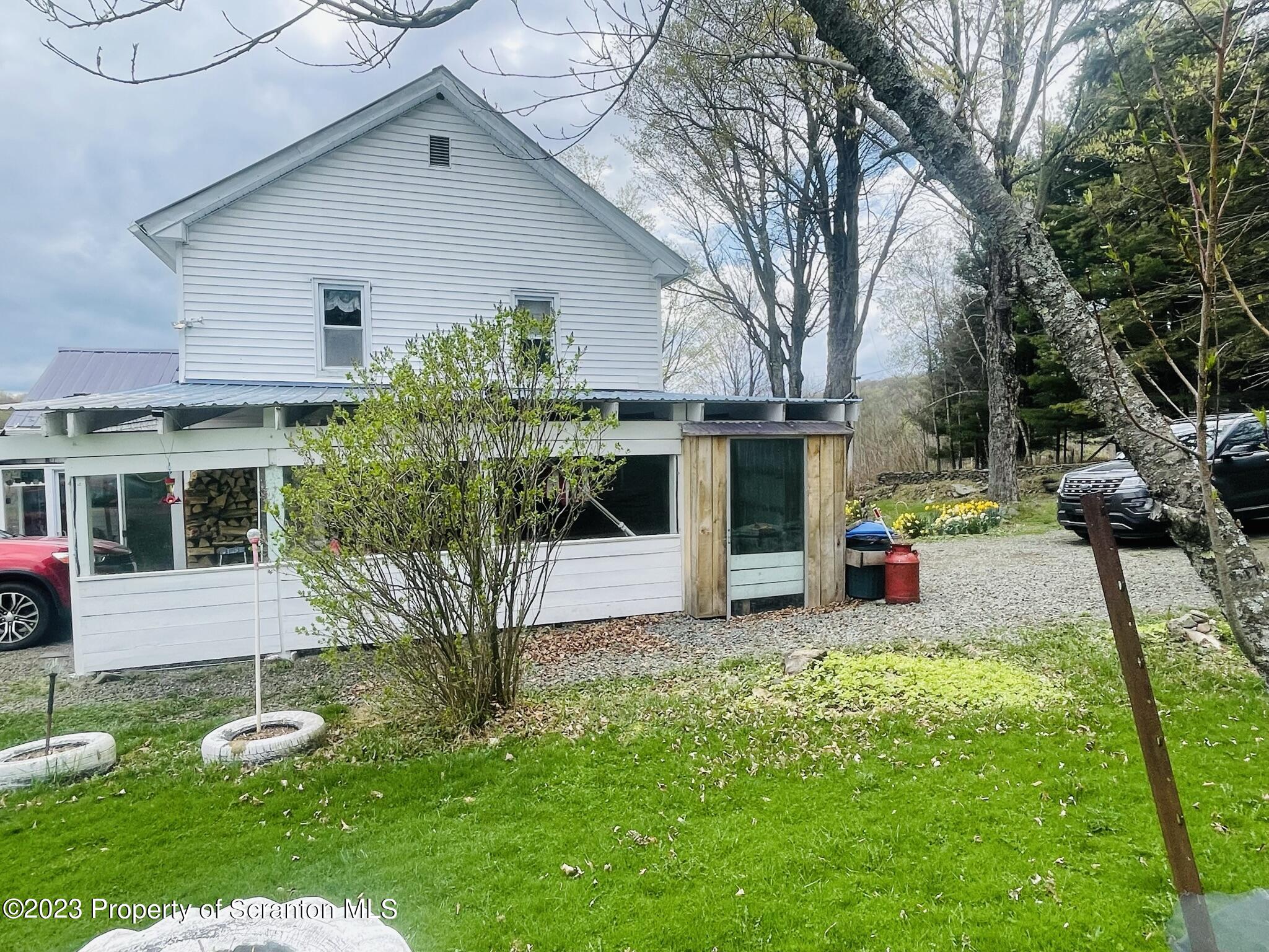 176 Stack Road Thompson, PA 18465 - Photo 33 of 53 a view of a house with backyard and sitting area