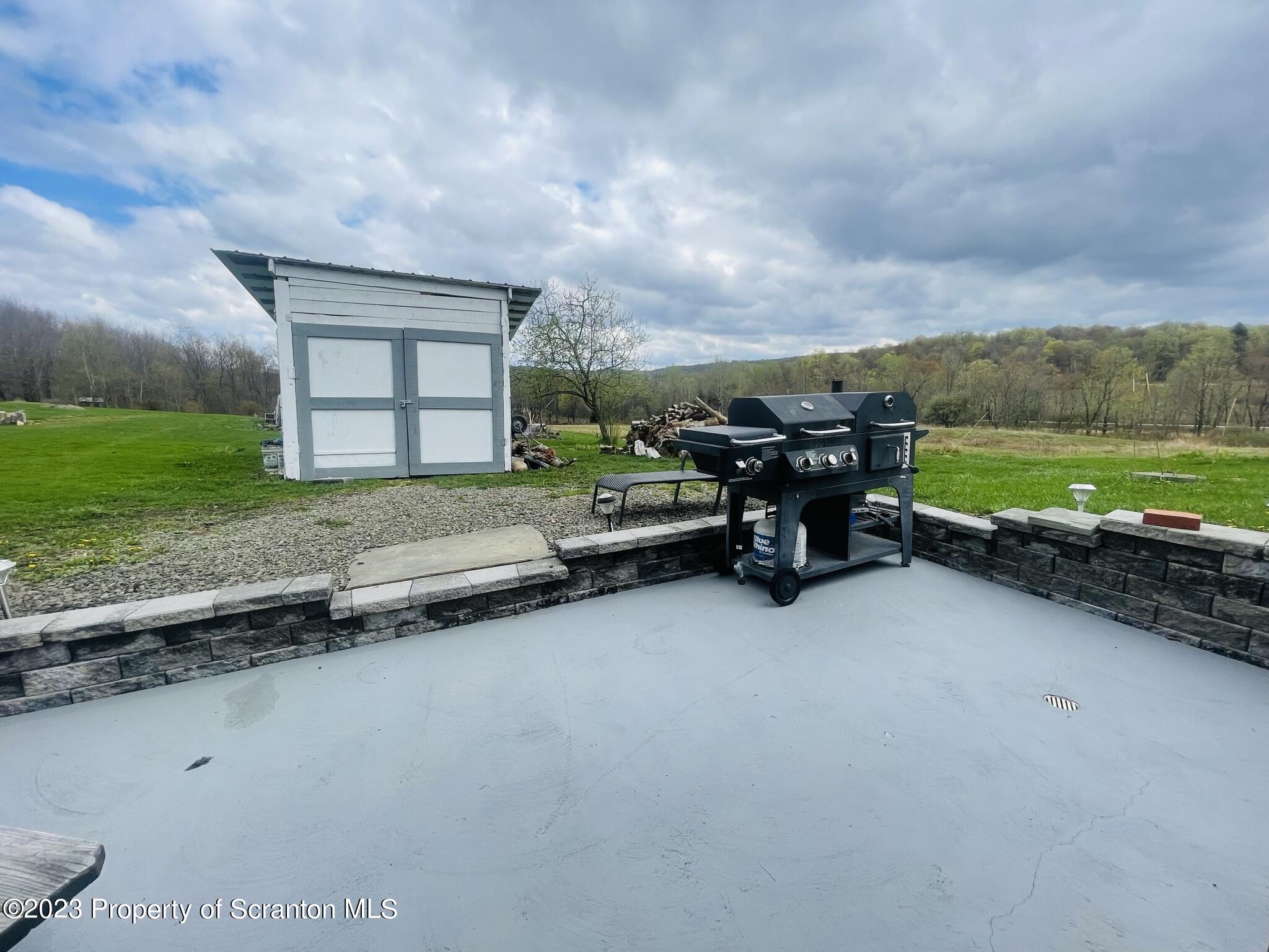176 Stack Road Thompson, PA 18465 - Photo 35 of 53 a view of a swimming pool and lounge chairs in back of a yard