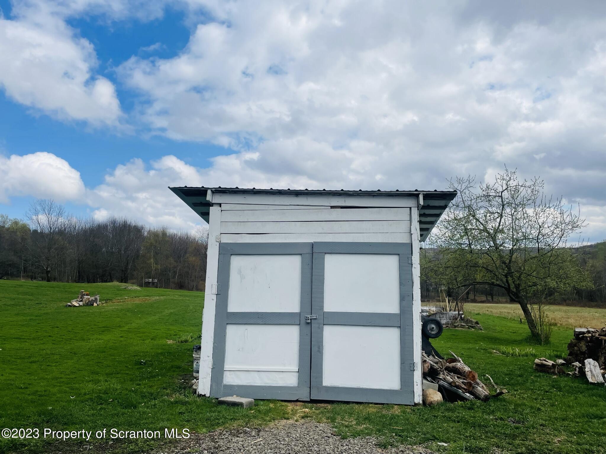 176 Stack Road Thompson, PA 18465 - Photo 36 of 53 a view of a tiny house with backyard