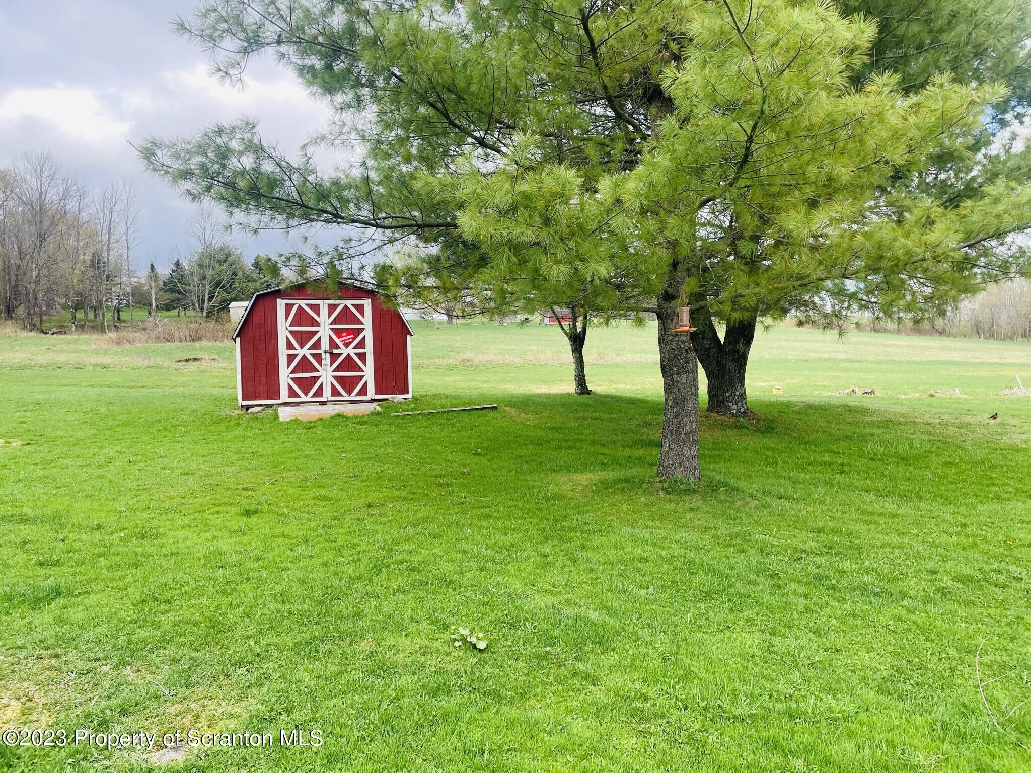176 Stack Road Thompson, PA 18465 - Photo 38 of 53 a sign board in the middle of a field