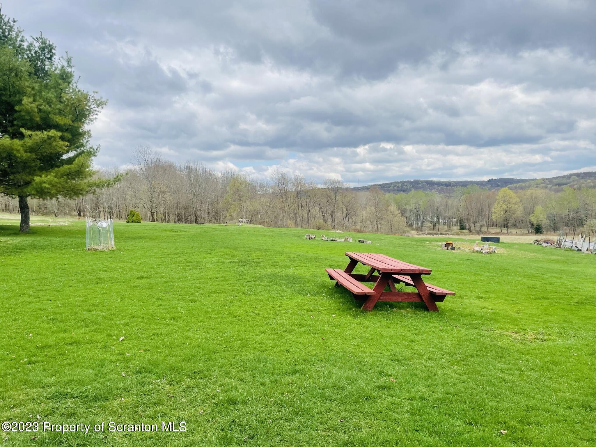 176 Stack Road Thompson, PA 18465 - Photo 40 of 53 a view of a garden with lawn chairs