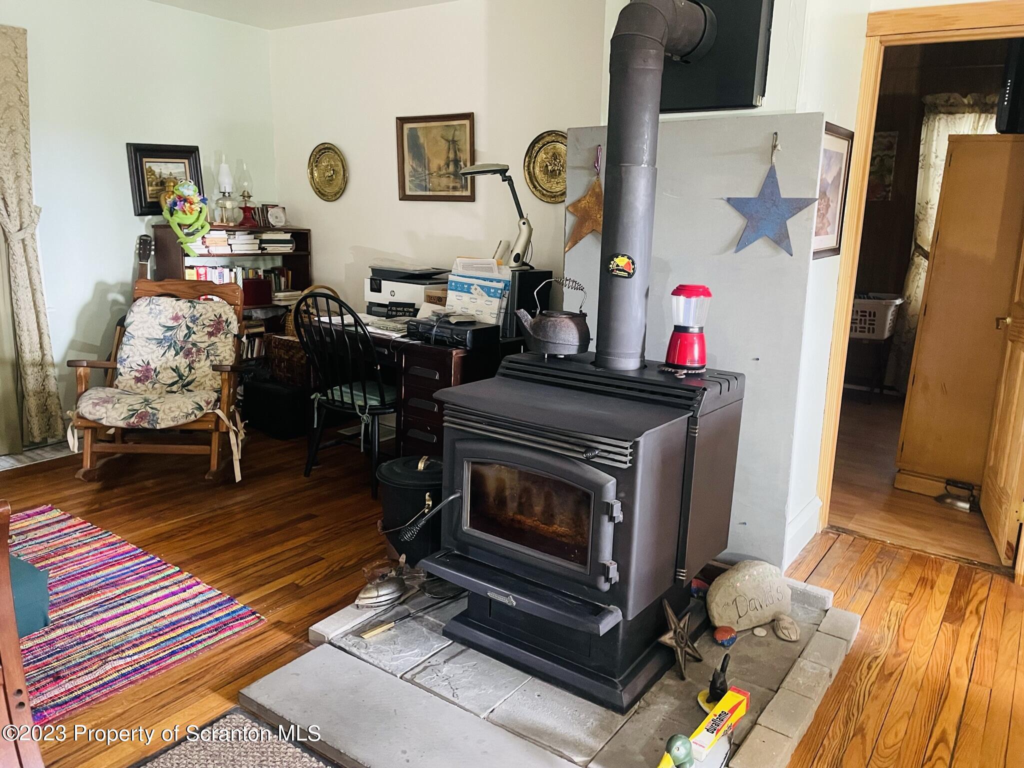 176 Stack Road Thompson, PA 18465 - Photo 4 of 53 a living room with furniture and a fireplace