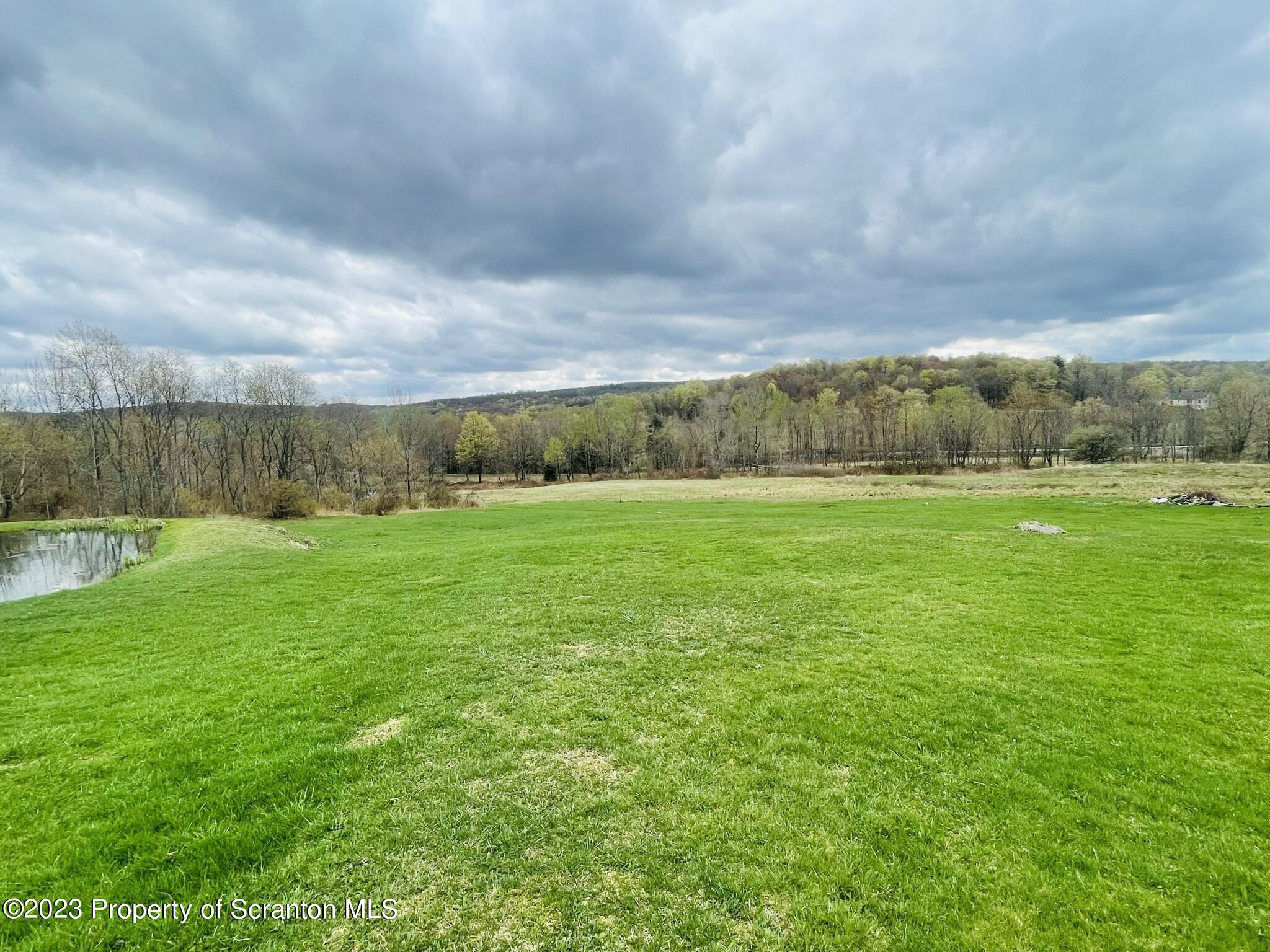 176 Stack Road Thompson, PA 18465 - Photo 45 of 53 a view of grassy field with ocean in the background