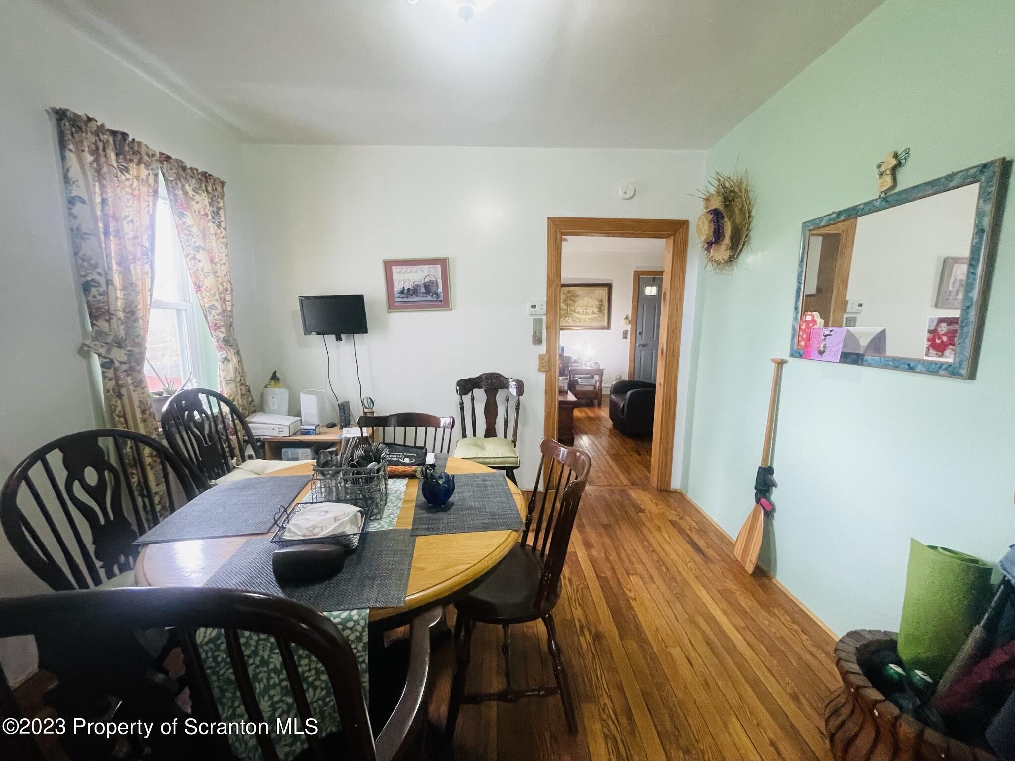 176 Stack Road Thompson, PA 18465 - Photo 5 of 53 a view of a dining room with furniture and wooden floor