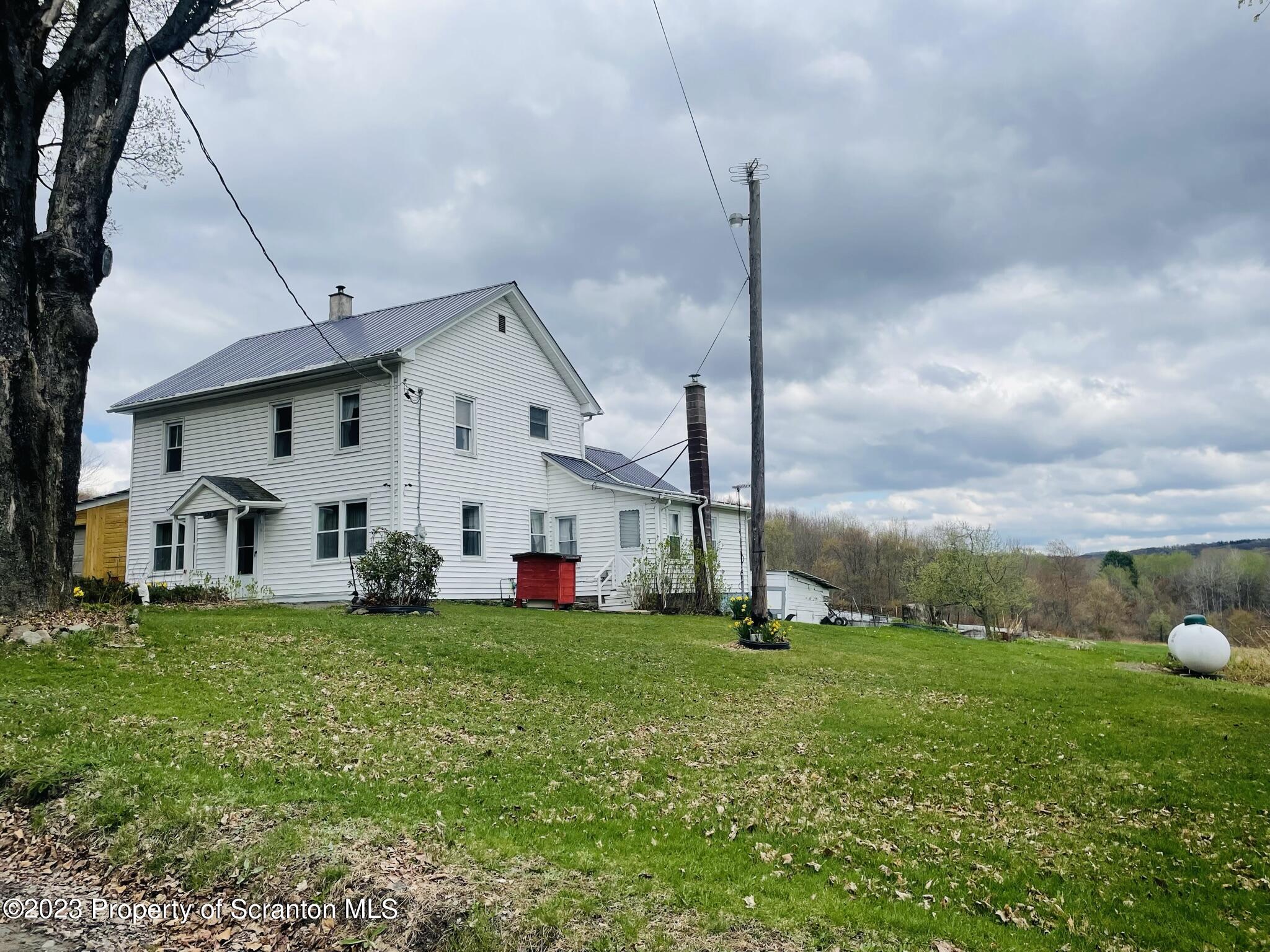 176 Stack Road Thompson, PA 18465 - Photo 51 of 53 a view of a house with a yard