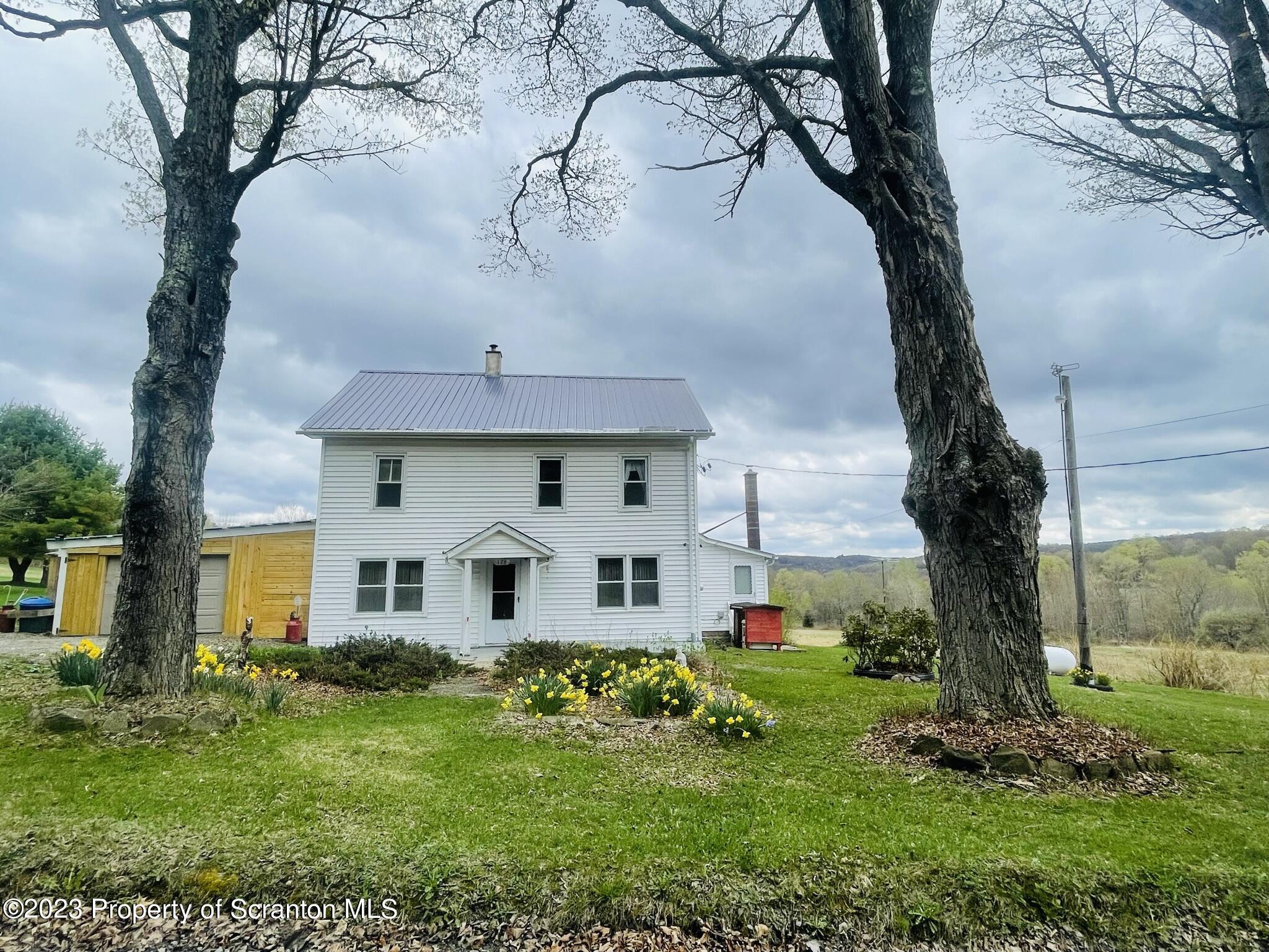 176 Stack Road Thompson, PA 18465 - Photo 52 of 53 a front view of a house with a yard