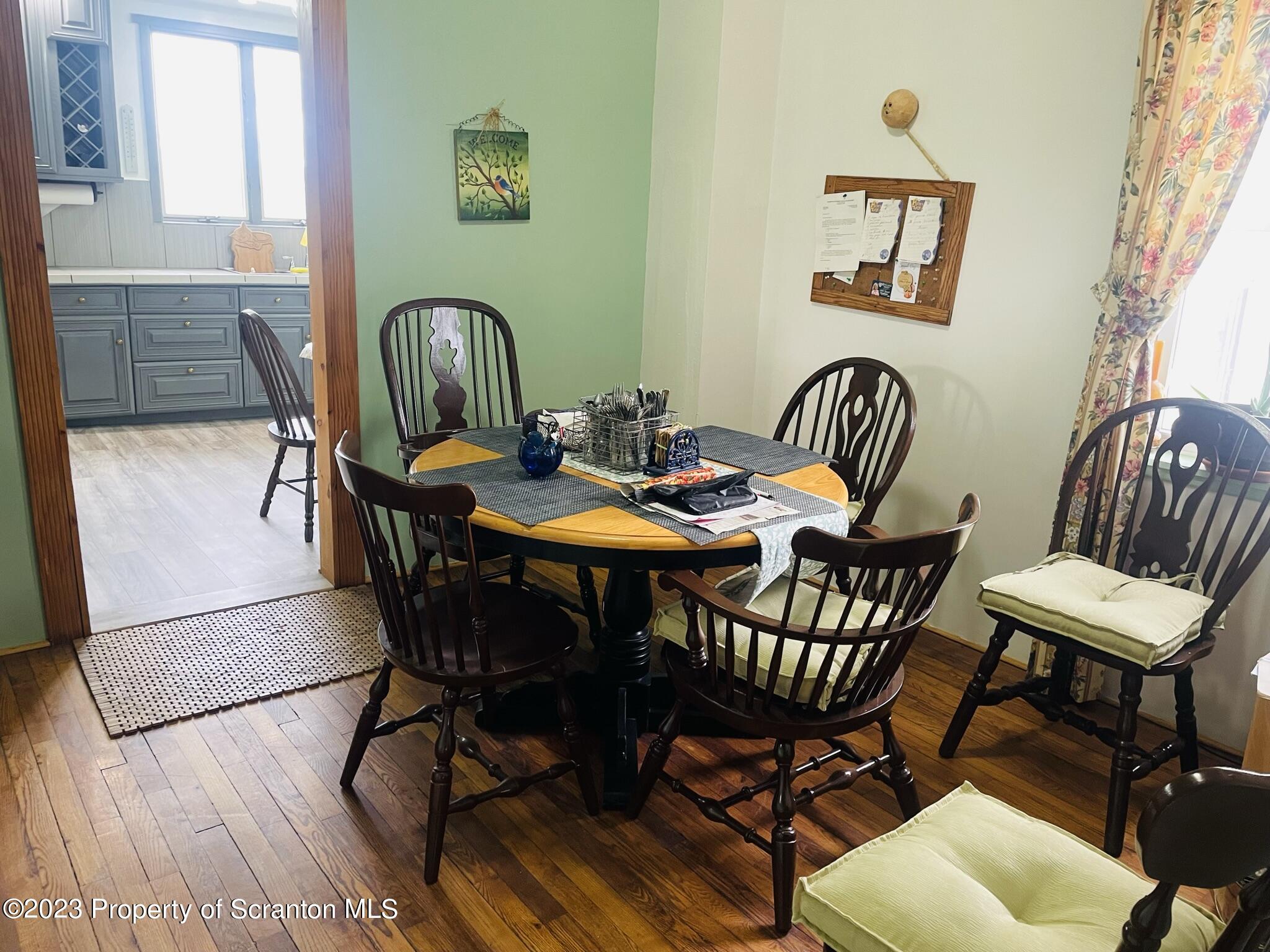 176 Stack Road Thompson, PA 18465 - Photo 6 of 53 a view of a dining room with furniture and wooden floor