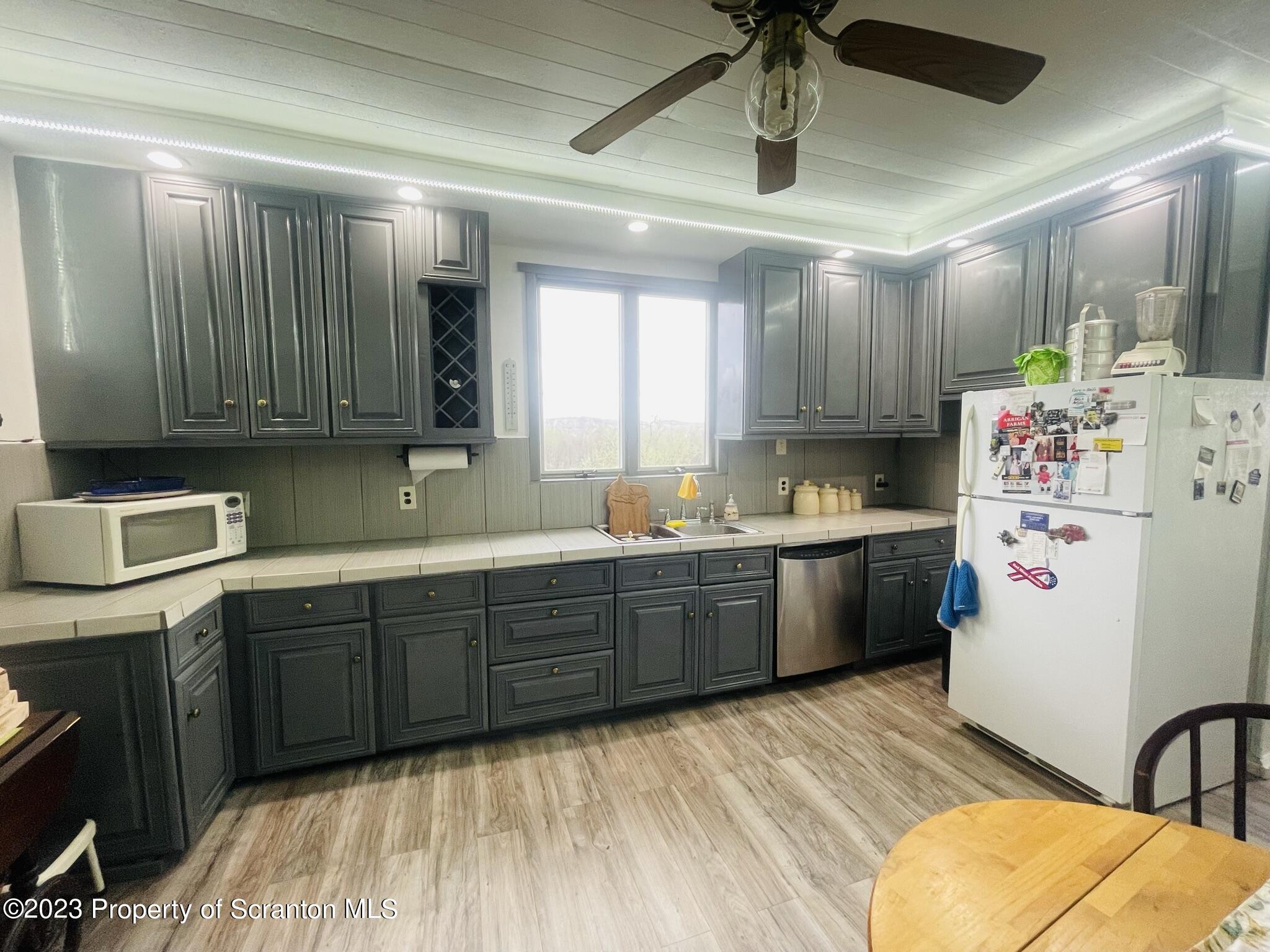 176 Stack Road Thompson, PA 18465 - Photo 7 of 53 a kitchen with refrigerator and cabinets