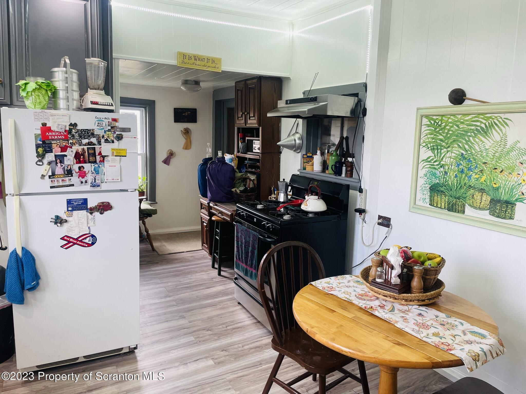 176 Stack Road Thompson, PA 18465 - Photo 9 of 53 a view of a dining room with furniture a chandelier windows and wooden floor