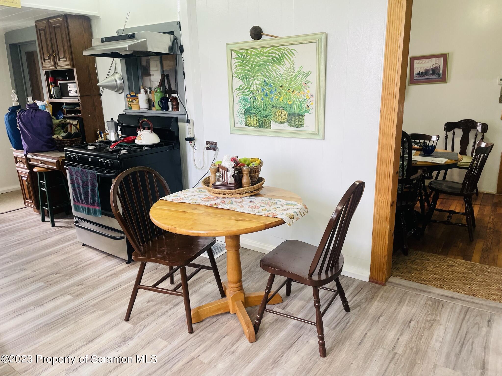 176 Stack Road Thompson, PA 18465 - Photo 10 of 53 a view of a dining room with furniture and wooden floor