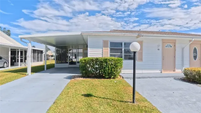 a swimming pool with outdoor seating and yard