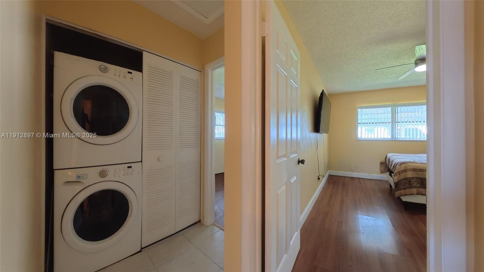 10 Dawn Flower Circle Lehigh Acres, FL 33936 - Photo 19 of 25 a view of a hallway with washer and dryer