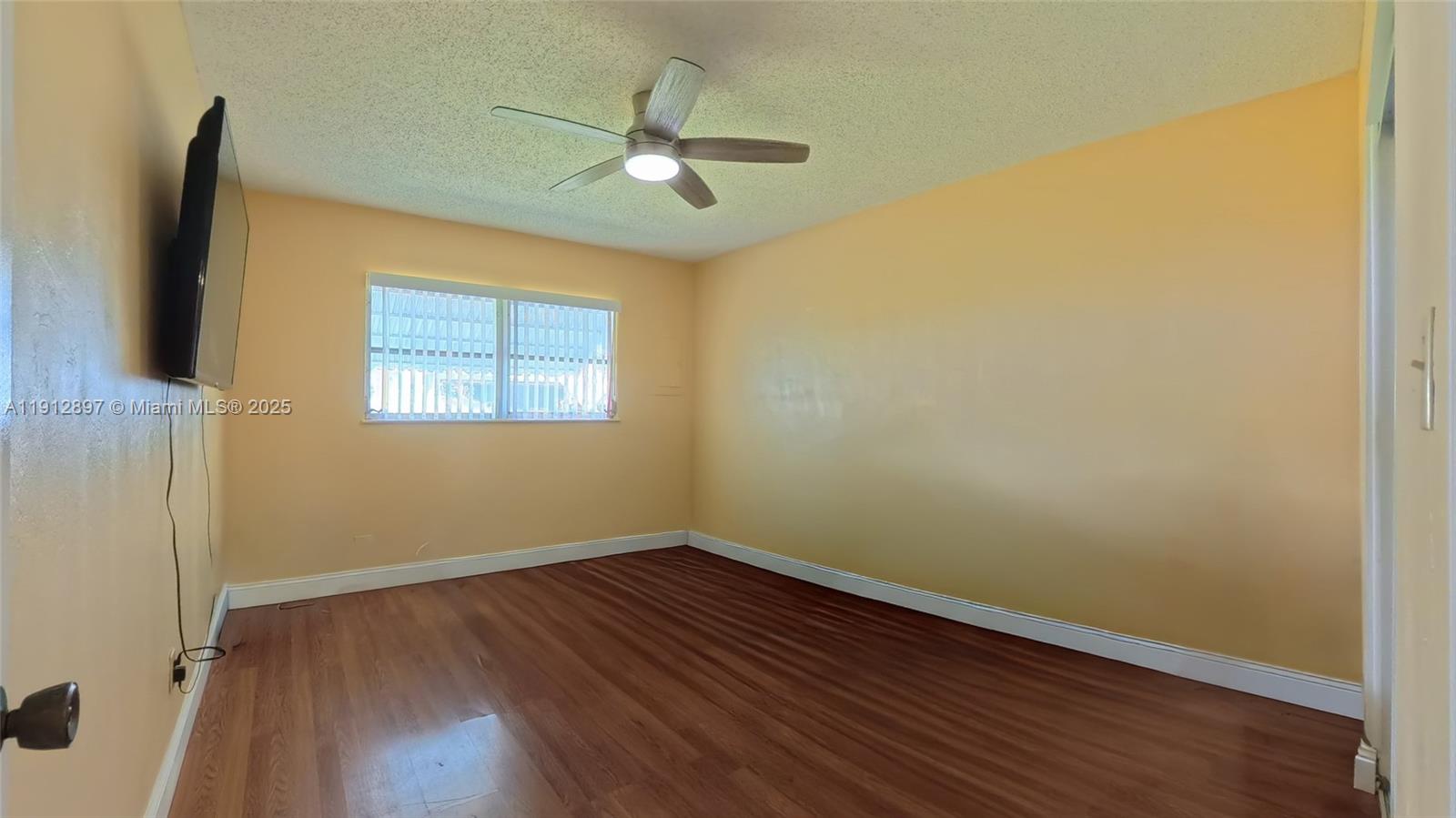 10 Dawn Flower Circle Lehigh Acres, FL 33936 - Photo 20 of 25 a view of a room with wooden floor and fan