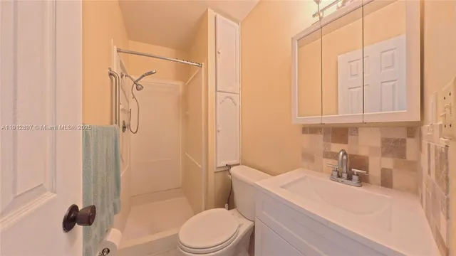 a white toilet sitting next to a bathroom sink