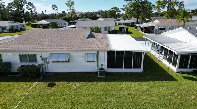 a view of a house with pool and a yard
