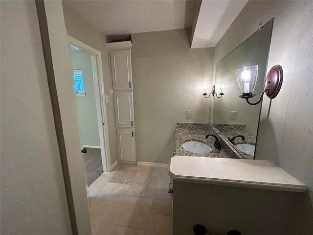a bathroom with a sink and mirror