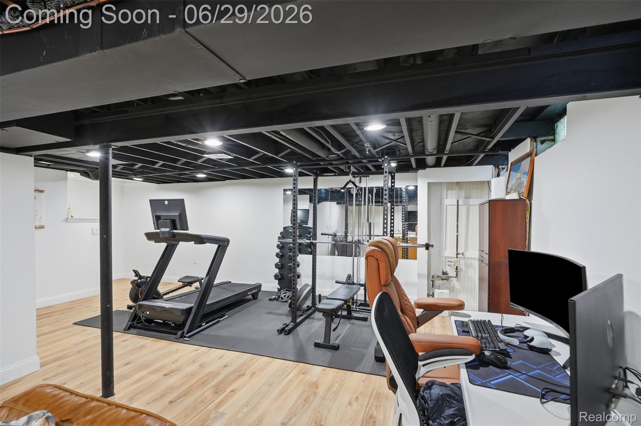 45179 Rudgate Road Canton, MI 48188 - Photo 24 of 48 Finished lower level featuring exposed black ceiling joists, recessed lighting, light wood-finish flooring, and white walls