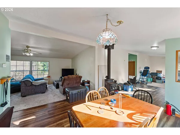 a view of a dining room with furniture a chandelier and wooden floor
