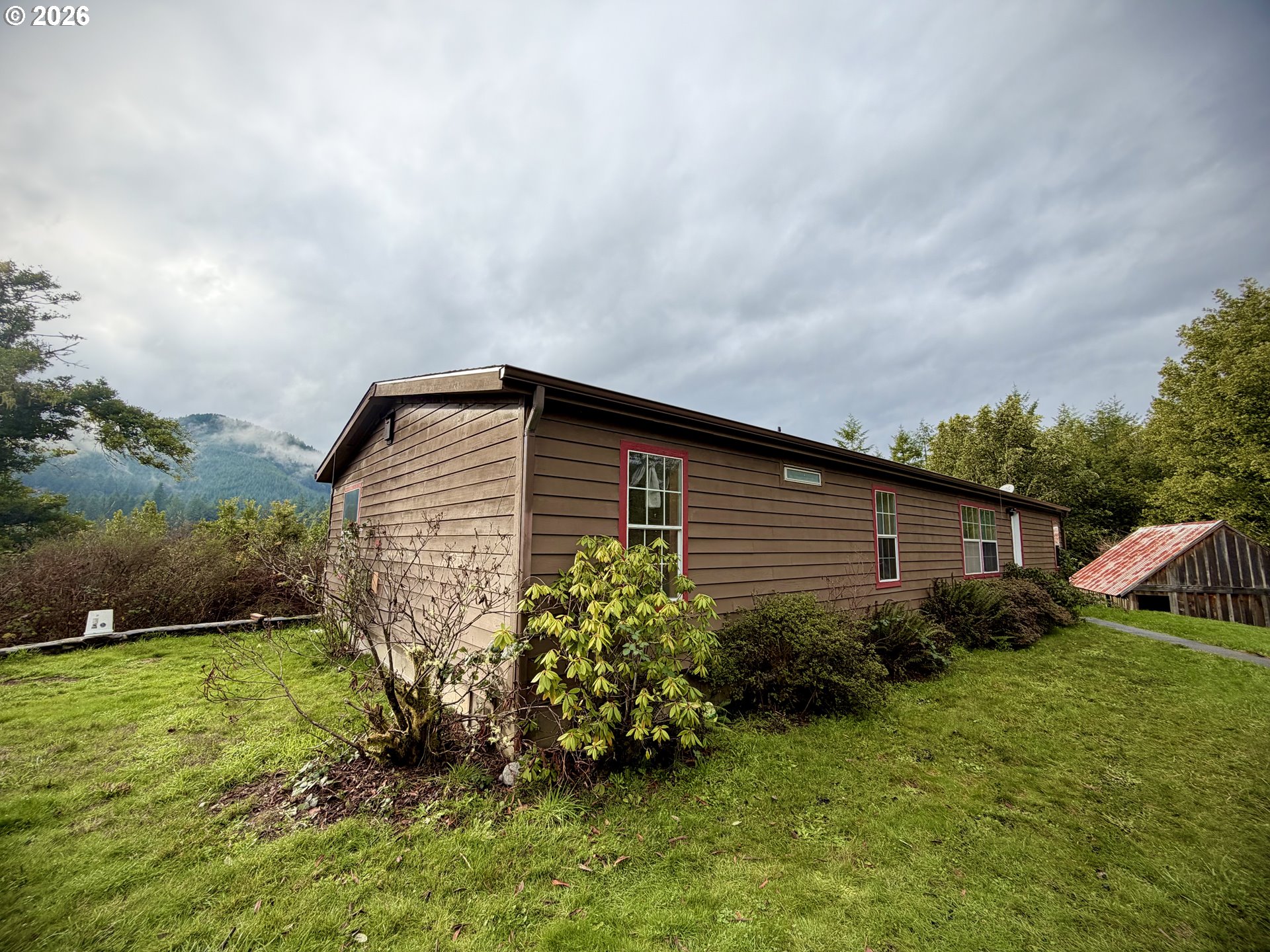 41308 South Powers Road Powers, OR 97466 - Photo 4 of 42 a backyard of a house with lots of green space