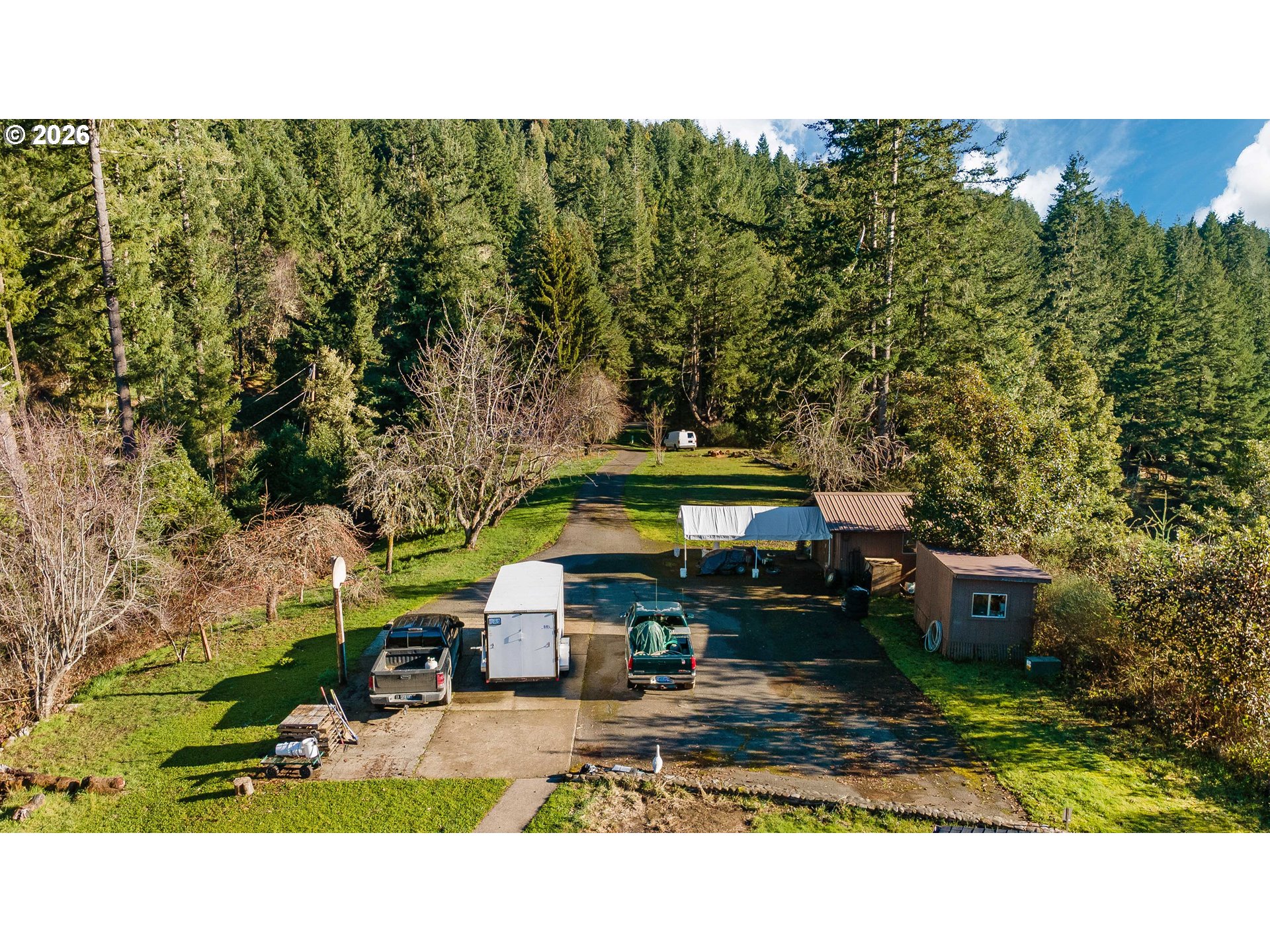 41308 South Powers Road Powers, OR 97466 - Photo 41 of 42 a balcony with outdoor seating and trees