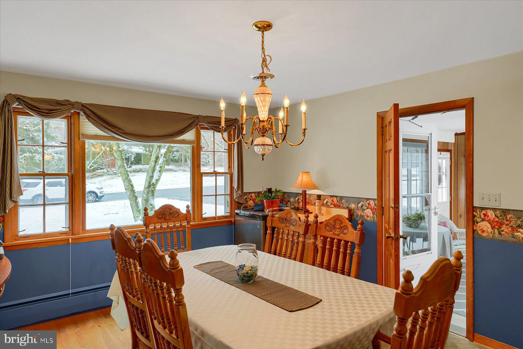 1105 Outer Drive State College, PA 16801 - Photo 11 of 44 a dining room with furniture a chandelier and wooden floor