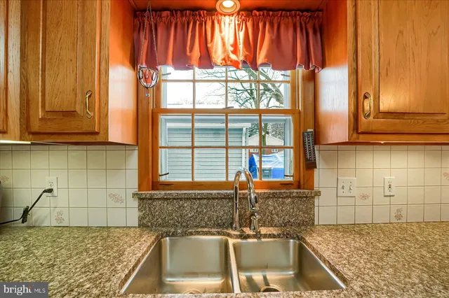 a kitchen with granite countertop a sink and a window