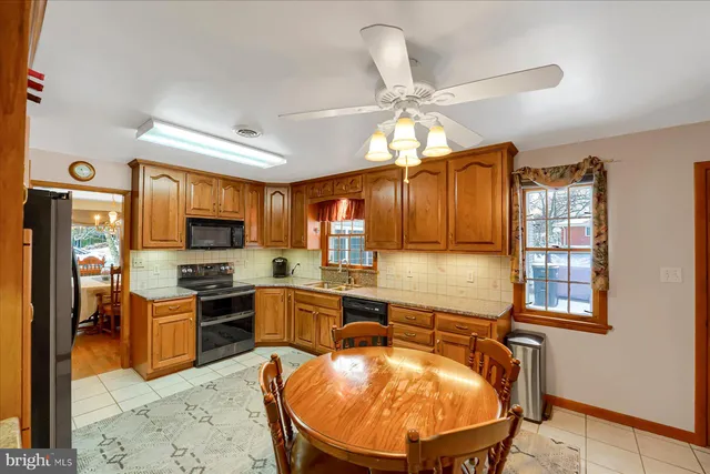 a living room with stainless steel appliances kitchen island granite countertop furniture and a kitchen view