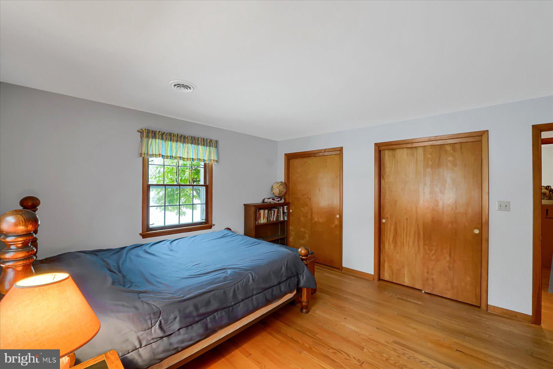 1105 Outer Drive State College, PA 16801 - Photo 22 of 44 a bedroom with a bed and wooden floor