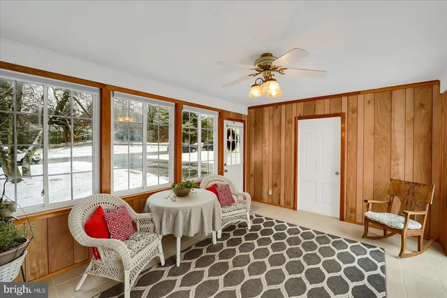 a bedroom with furniture and a large window