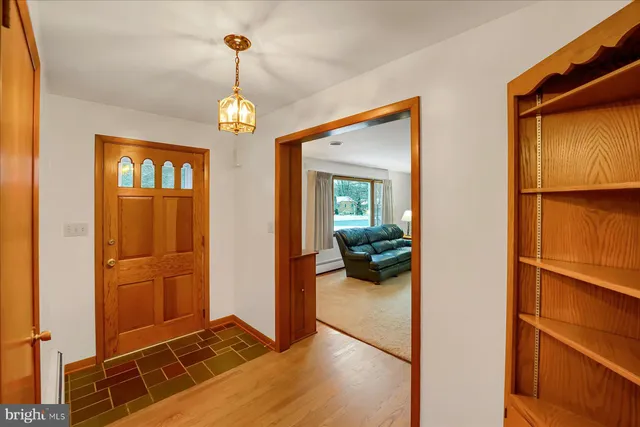 a view of a livingroom with furniture entryway and wooden floor
