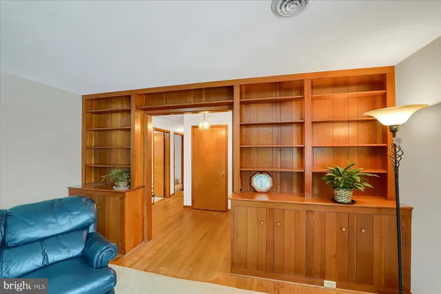a living room with a couch and cabinets