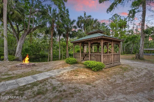 an aerial view of a house with a yard basket ball court and outdoor seating