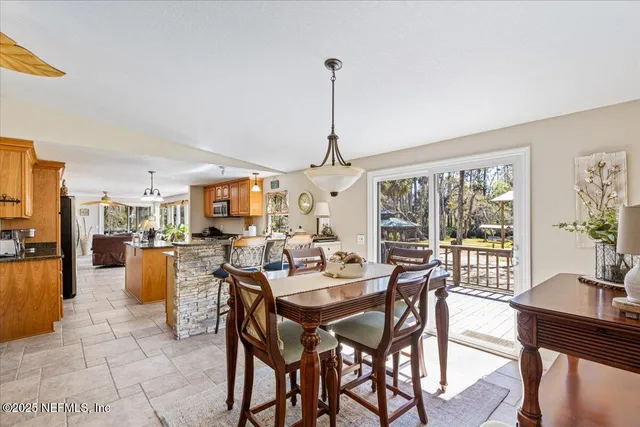 a dining room with furniture a chandelier and a rug