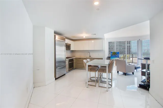 a kitchen with a table and chairs in it