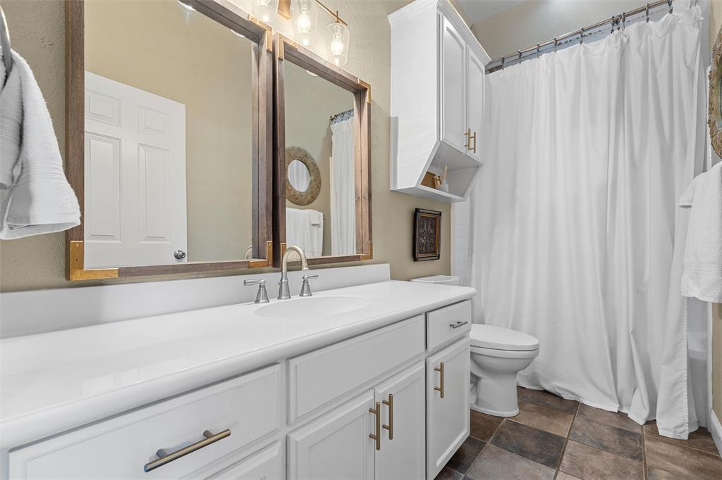 2030 Rustic Trail Waco, TX 76657 - Photo 27 of 40 a bathroom with double vanity sink a mirror and a bathtub