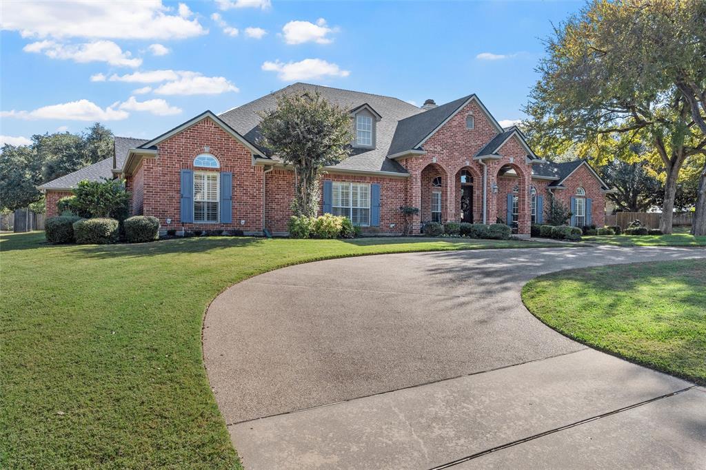2030 Rustic Trail Waco, TX 76657 - Photo 3 of 40 a front view of a house with a yard and garage