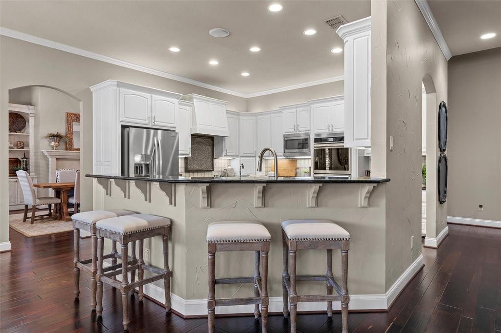 2030 Rustic Trail Waco, TX 76657 - Photo 9 of 40 a kitchen with stainless steel appliances granite countertop a table chairs refrigerator and sink