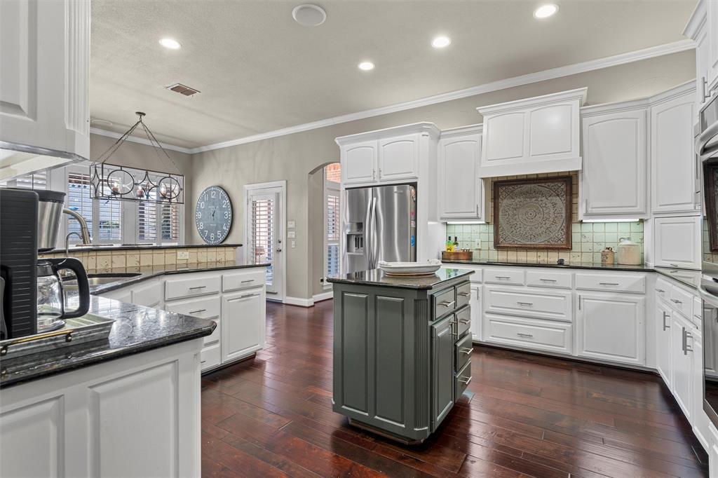 2030 Rustic Trail Waco, TX 76657 - Photo 10 of 40 a kitchen with granite countertop a sink cabinets and wooden floor