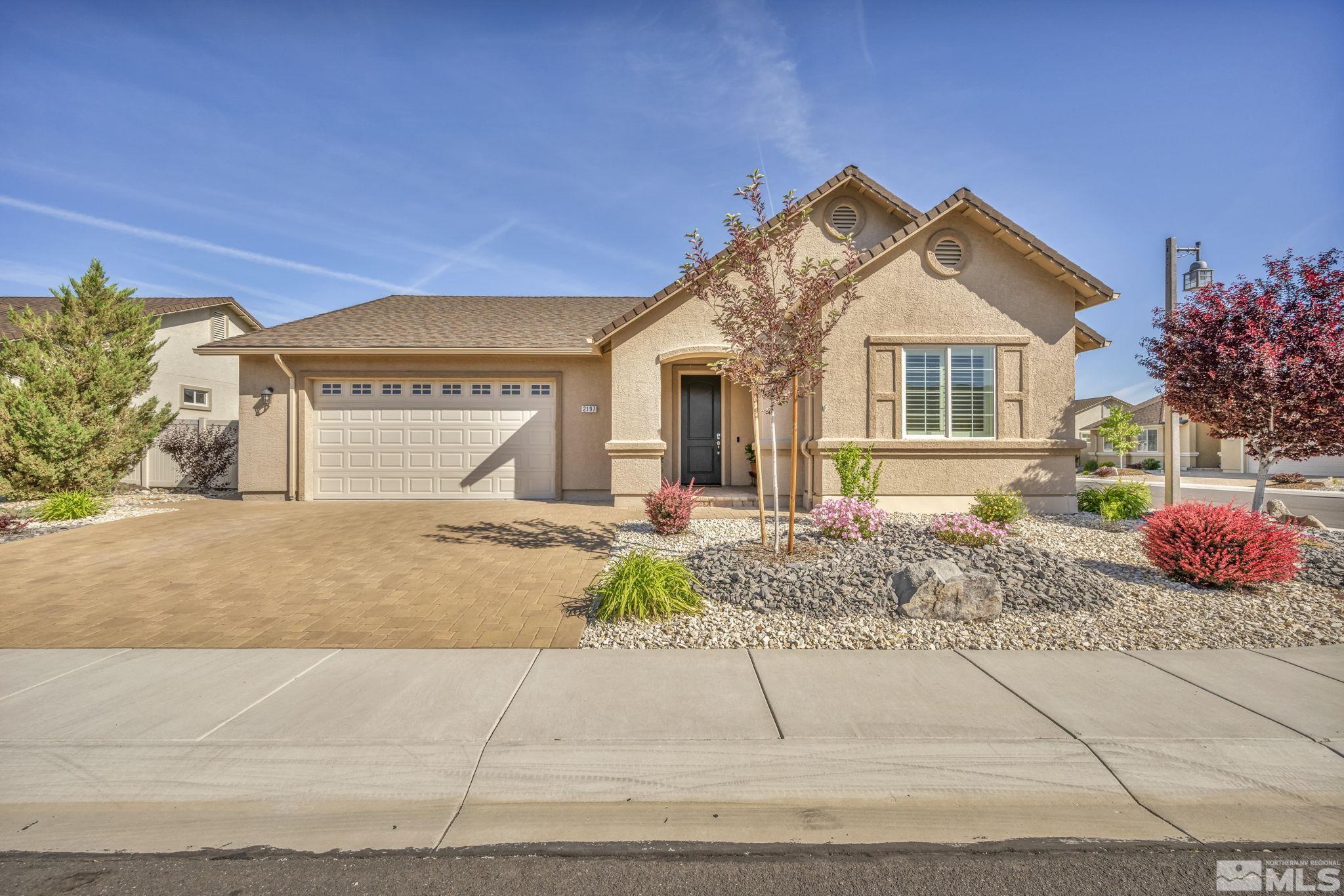 2197 Berkich Court Reno, NV 89521 - Photo 1 of 40 a front view of a house with a yard and a garage