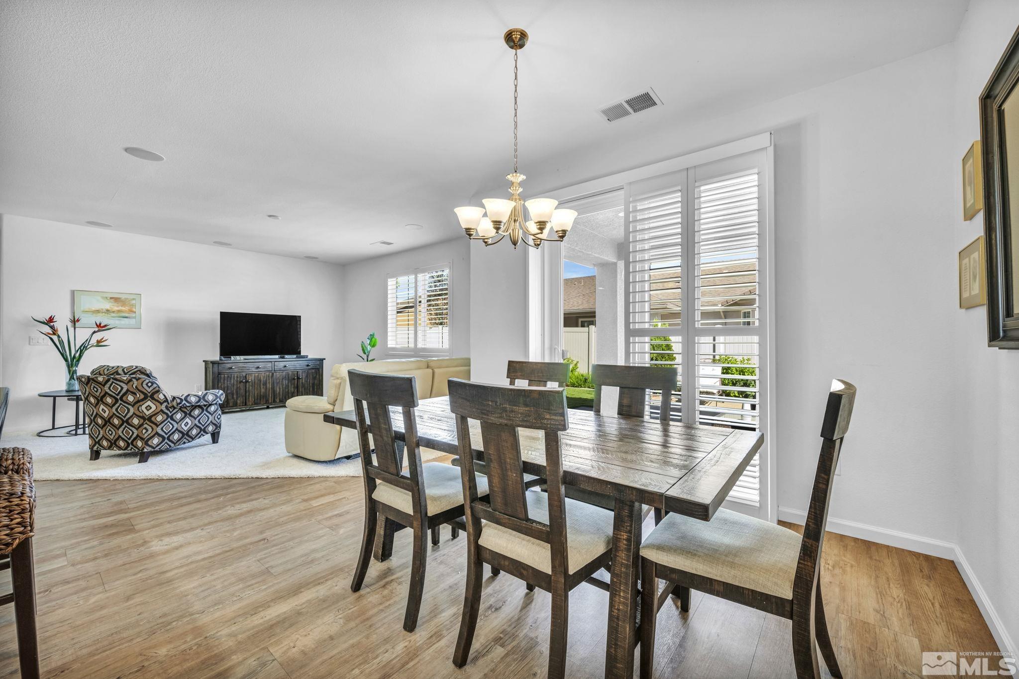 2197 Berkich Court Reno, NV 89521 - Photo 11 of 40 a view of a dining room with furniture and wooden floor