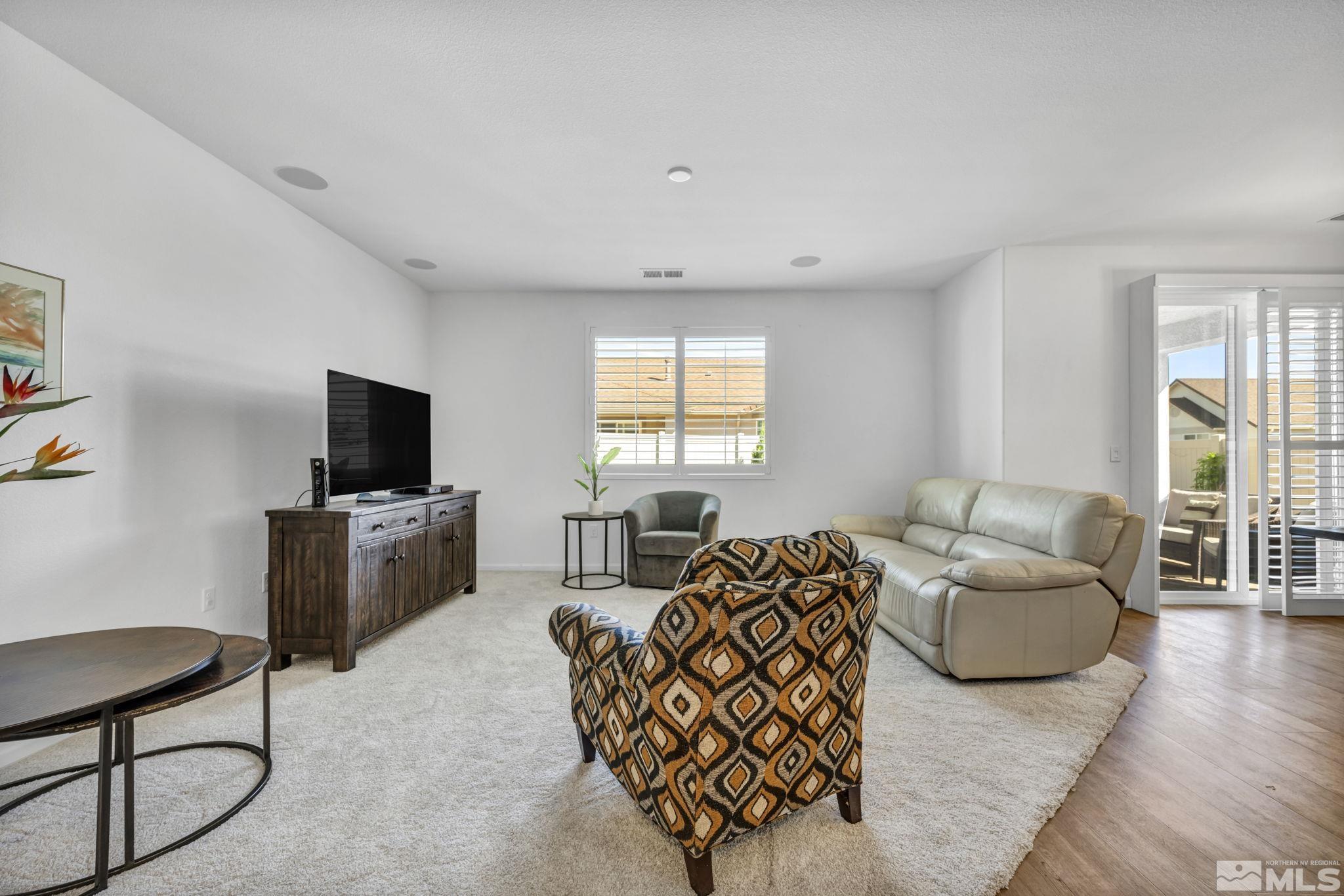 2197 Berkich Court Reno, NV 89521 - Photo 15 of 40 a living room with furniture a flat screen tv and a large window