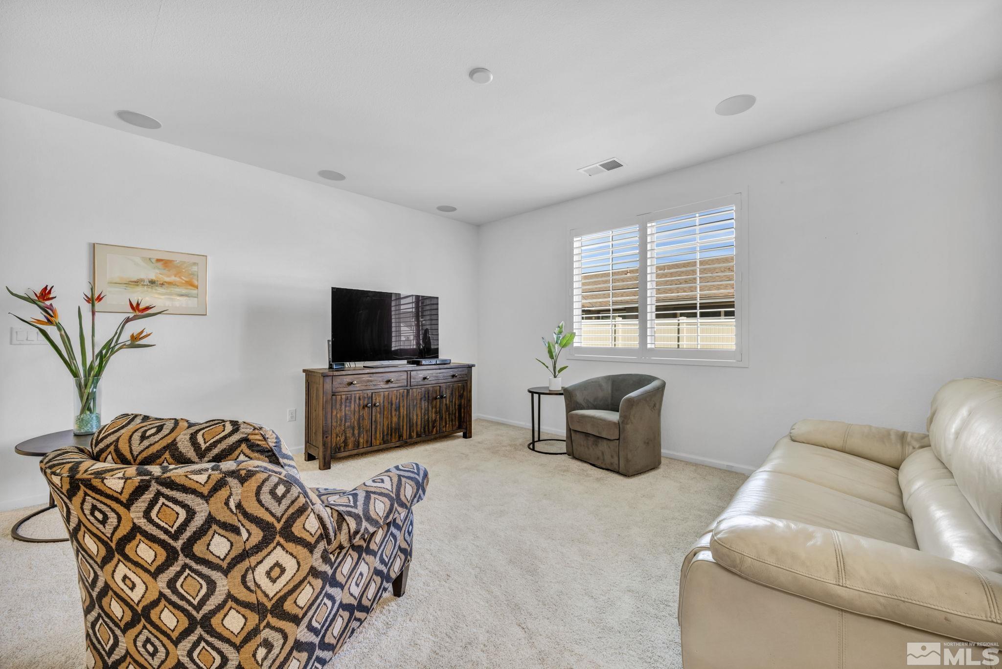 2197 Berkich Court Reno, NV 89521 - Photo 16 of 40 a living room with furniture and a flat screen tv